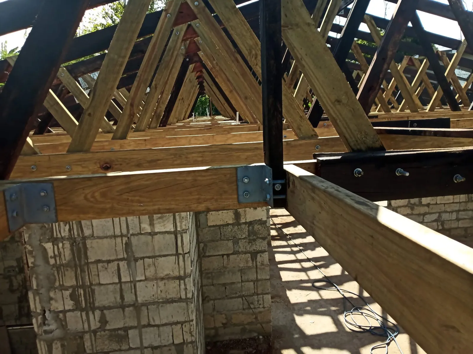 A home taking shape with walls and roof structure